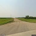 Semi trailer tipped on its side near rural residence