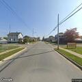 Man on bicycle wearing mask on Woodrow Avenue