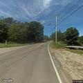 Dump truck spills gravel on roadway at intersection