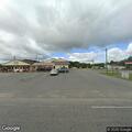 Person walking in roadway carrying garbage bag