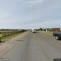 Man in distress holding fence near highway ramp