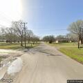 Person experiencing medical emergency at street corner in Grand Saline
