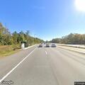 Person lying under overpass on Glen McConnell Parkway