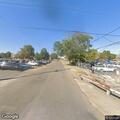 Person walking in middle of road near 3rd Street