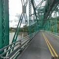 Person walking with flashlight on Joe Page Bridge