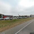 Loud music and crowd reported behind used car lot