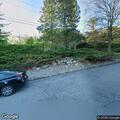 Parking complaint about green jeep on curb
