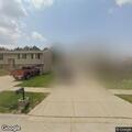 Officer checks parked blue Chevy Malibu sedan