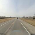 Abandoned RV with blown tire on highway shoulder