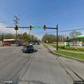 Officer checks two parked vehicles at intersection