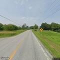 Person unresponsive in parked vehicle on local road