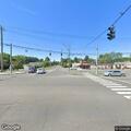 Disabled gray car blocking middle of roadway