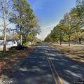 Person lying unconscious at park on Front Street