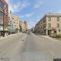 Man lying motionless with head under parked car in Chicago
