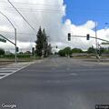 Person slumped forward in parked vehicle at intersection