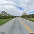 Woman walking on road appearing disoriented on Route 2