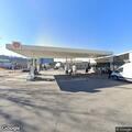 Person with back pain at gas station in Birmingham