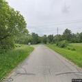 Disabled combine tractor partially blocking roadway