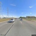 Person down on grass with leg injury at intersection
