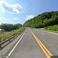 Person with bat walking in road on Route 52