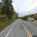 Person conscious with apparent leg pain lying in road