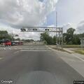 Man with rifle and camera walking along US 301