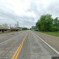 Pedestrian walking along Highway 76 for phone service