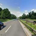 Pedestrian walking in highway median near rest area