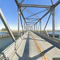 Person standing on rails of Old River Bridge possibly to jump