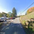 Car partially over embankment on Spring Street