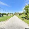 Person walking in roadway toward Grant St