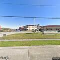 Older woman having headache at Woodmere School