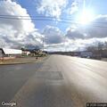 Disabled vehicle with blown tire at highway intersection