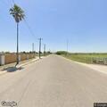 Man sitting by wall at Hidalgo Basin asks for water