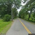 Suspicious person standing with bicycle on roadside