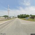 Officer checks black Cadillac at intersection
