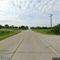 Slow-moving farm vehicle blocking highway lanes