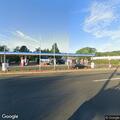 Disabled vehicle with suspended plate at gas station