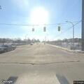Unknown female walking with white sheet at intersection
