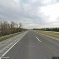 Motorist in red shirt flags down vehicle on US-63
