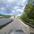 Vehicle stopped with hazard lights on Main Street