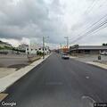 Person found motionless lying in grass at city intersection