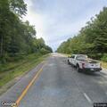 Silver SUV parked in highway median near exit 39