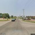 Female sitting on roadside at intersection in Guthrie