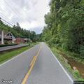 Motorcycle crash into creek injures woman rider