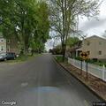 Tree branch on wires creating road hazard