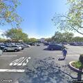 Man walking with two baseball bats near marketplace