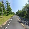 Elderly woman with walker on roadside of Route 22