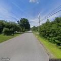 Older man with vision issues walks slowly in road