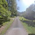 Male walking on road appears out of breath on Maple Road